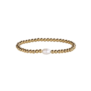 Polished gold stainless steel bead bracelet with a baroque freshwater pearl centerpiece