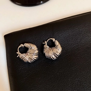 Geometric C-shaped textured metal hoop earrings with a modern minimalist style