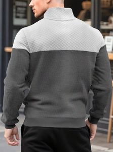 Detailed back view of men's knit polo shirt with gray patchwork and diamond quilting