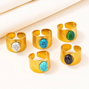 Detailed view of bohemian gold adjustable rings with sunburst pattern and colorful stones