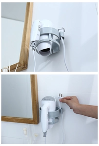 Detail of wall-mounted hair dryer holder with integrated plug storage hook