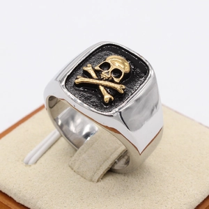 Retro punk men's signet ring featuring a gold skull on black rectangular face