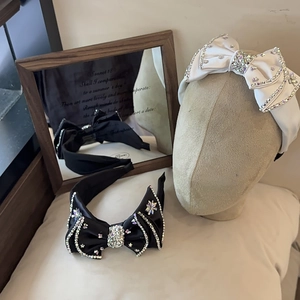 Detail of luxury satin headbands with sparkling rhinestone bows and star accents