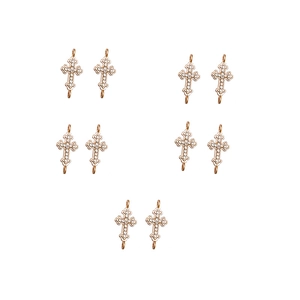 Close-up of ten rose gold cross connectors with inset rhinestones for DIY jewelry making