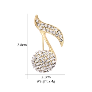 Detail view of a luxury gold music note brooch with dimensions 3.8cm by 2.1cm