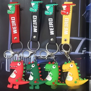 Close-up of colorful cartoon dinosaur silicone keychains with metal rings and soft straps