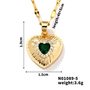 Detail showing heart-shaped green zircon pendant with sunburst texture and dimensions