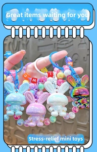 Detail of colorful acrylic rabbit keychain charms with letter beads and heart patterns