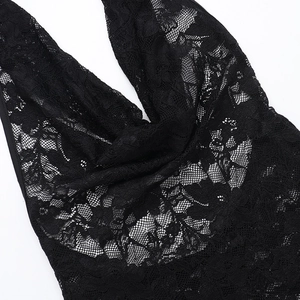Close-up of intricate black floral lace pattern and sheer texture on a backless dress