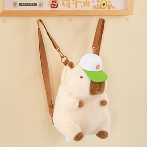 Close-up of plush Capybara backpack with a green cap hanging on a wall hook