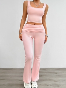 Detail of light pink knit two-piece set featuring square neck crop top and flared pants