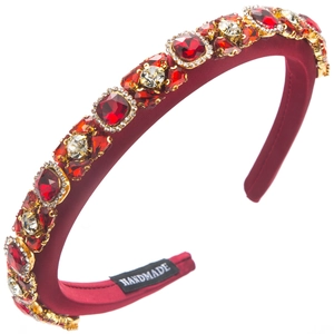 Detail of luxury burgundy velvet headband with large red crystals and handmade label