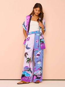 Detail of tropical print two-piece set featuring short-sleeved cardigan and wide-leg pants