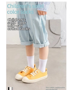 Detail of white thin cotton mid-calf socks for kids featuring breathable and deodorant fabric