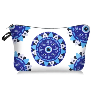 Detail of waterproof makeup bag with Evil Eye mandala prints and black handle strap