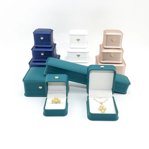 Close-up of assorted PU leather jewelry boxes with gold crown logo and white lining