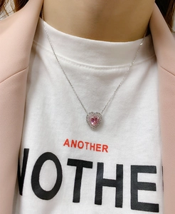 Close-up of heart-shaped pink carbon diamond necklace with double halo on silver chain