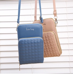 Detail of checkered embossed leather crossbody phone bag with adjustable metal buckle strap