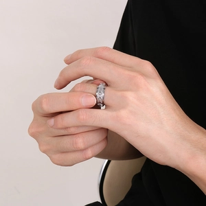 Detail of vintage silver spinner ring with engraved sun and moon patterns on finger