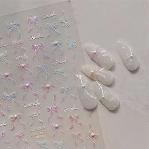 Detailed 5D embossed bow nail art stickers with faux pearls on manicured tips