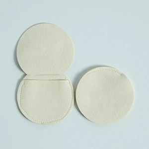 Detail of round beige microfiber jewelry pouch in both open and closed positions