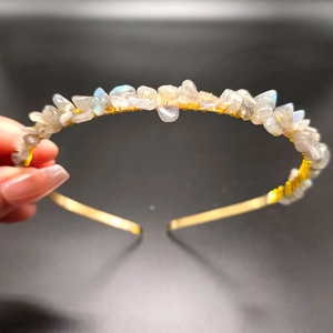 Detailed macro view of handmade crystal headband with moonstone chips on gold wire