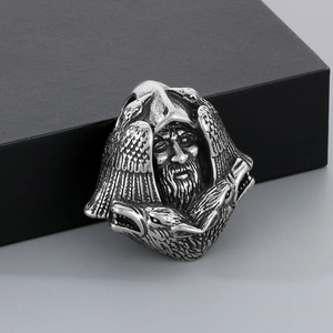 Macro detail of Nordic Odin pendant with raven engravings in polished stainless steel