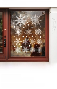 Detailed view of white snowflake window stickers on glass for Christmas home decor