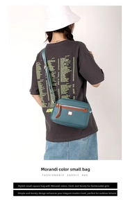 Detail of blue nylon crossbody bag with brown leather trim and adjustable shoulder strap