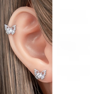 Detailed view of butterfly butterfly ear bone stud with heart-shaped zircon in titanium steel