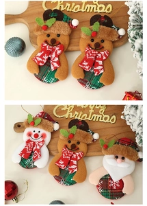 Detail of knitted Christmas tree ornaments featuring Santa and snowman with golden hanging strings