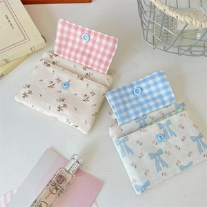 Detail showing two floral canvas card holders with snap button and zipper closure
