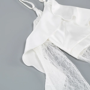 Detailed close-up of white lace ruffles and adjustable satin strap on this chic top