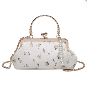 White lace shell bag with floral embroidery and golden metal handle and chain strap