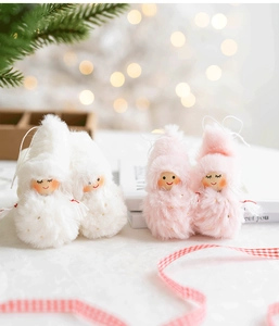 Detail of plush Christmas angel doll with soft faux fur texture and hand-painted face