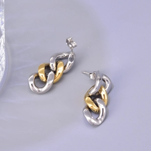 Detail of two-tone gold and silver chain link drop earrings in polished titanium steel