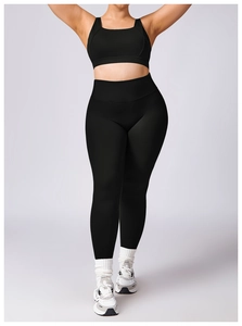 Front view of black plus size yoga set with U-neck sports bra and high-waist leggings