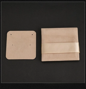 Detail view of beige velvet jewelry pouch with display card and elegant ribbon tie