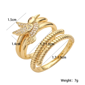 Detailed view of gold hummingbird ring and spiral bands with precise size measurements