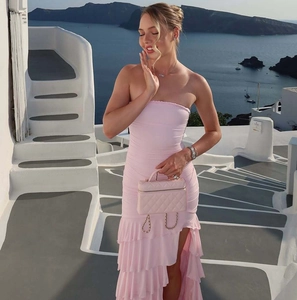 Detail of pink strapless tiered maxi dress with layered ruffles and high side slit