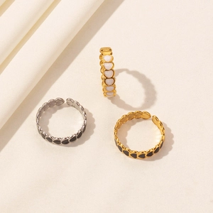 Three minimalist heart drip oil open rings in gold and silver on beige fabric