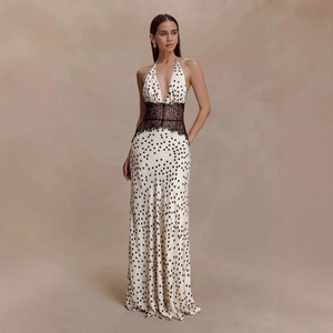 Detail of deep V-neck white maxi dress with black polka dots and lace waist design