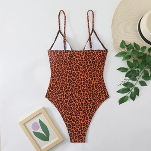 Detailed flat lay of orange leopard print one-piece swimsuit with adjustable straps