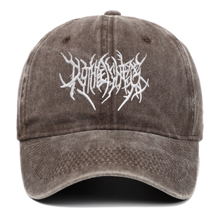 Detail of Gothic white embroidery on vintage washed brown street punk baseball cap