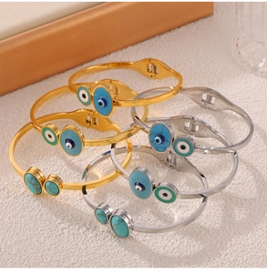 Detailed shot of titanium steel bracelets with Evil Eye and turquoise enamel inlay