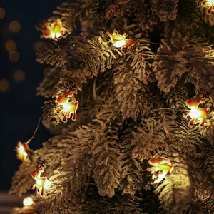 LED Christmas reindeer string lights emitting warm yellow light on a snowy tree