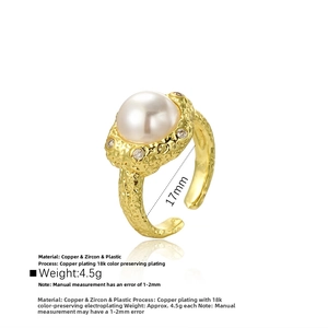 Detail of 18k gold plated ring with large baroque pearl and zircon accents on hammered band