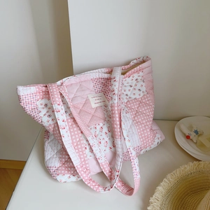 Pink floral quilted cotton tote bag with patchwork patterns and soft padded shoulder straps