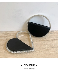 Detail of black leather evening clutch bags featuring heart and semi-circle rhinestone handles