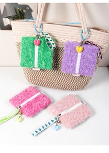 Macro detail of plush square wallets with heart zippers and colorful faux fur texture